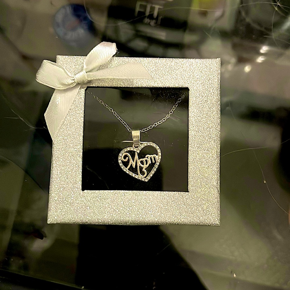 Cute little mom necklace. Silver with diamonds and mom designed in cursive.
